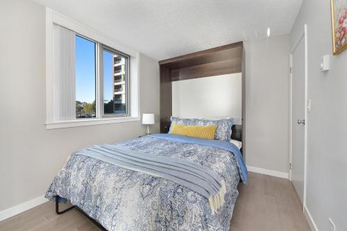 a bedroom with a bed and a window at Victoria West Harbourview in Victoria