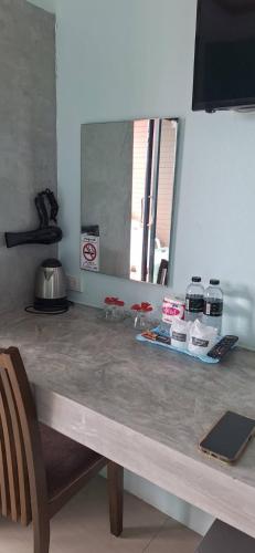 a counter in a kitchen with a table and a mirror at The Aireen Hotel in Ao Nang Beach