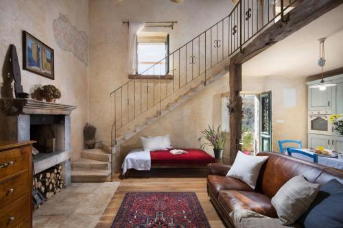 a living room with a couch and a bed at Villa Malini with Pool, Sauna and Fenced Garden in Labin