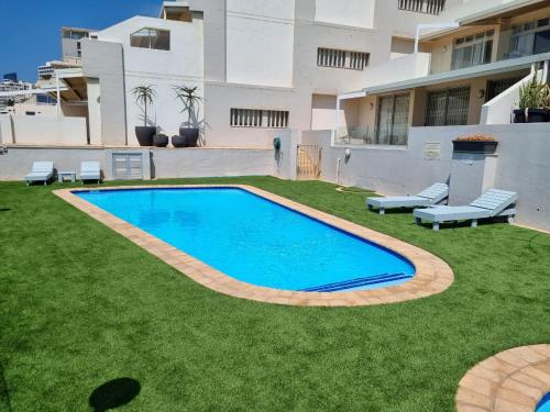 a swimming pool in the yard of a house at 602 MARBELLA UMHLANGA DURBAN in Durban