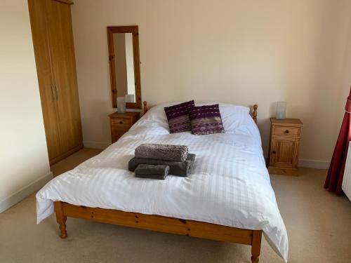 a bedroom with a bed with towels on it at Gras Lawn B&B in Exeter