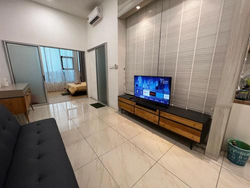 a living room with a flat screen tv on a entertainment center at ITCC Manhattan Suites by Blossom37 in Donggongon