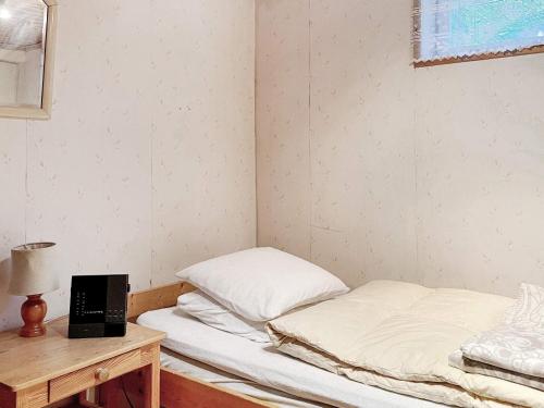 a small room with a bed and a desk with a laptop at Holiday home BROMMA II in Stockholm