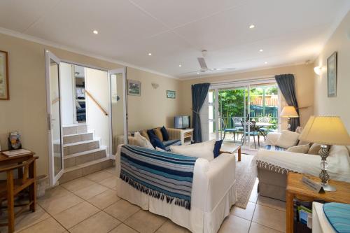 a living room with a couch and a table at Dunwerkin Self Catering in Kenton on Sea