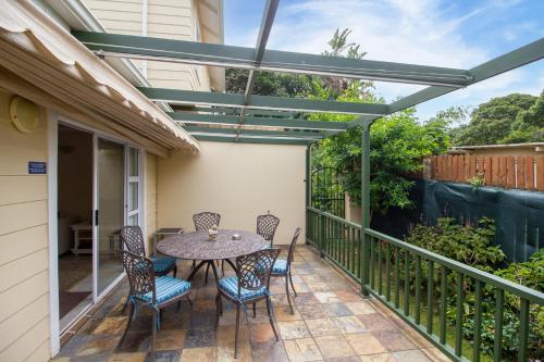 a patio with a table and chairs on a balcony at Dunwerkin Self Catering in Kenton on Sea