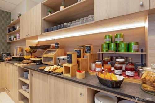 a kitchen with a counter with food on it at ibis Styles Cannes Le Cannet in Cannes