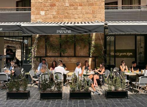 a group of people sitting at tables outside a restaurant at Batroun boutique suites in Batroûn
