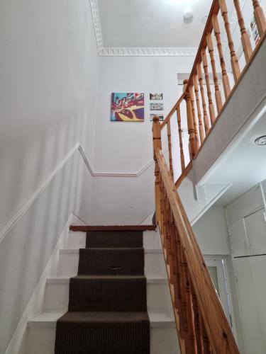 a staircase with white walls and wooden railings at Spacious room private balcony - Central London - zone 1 - Elephant and Castle in London