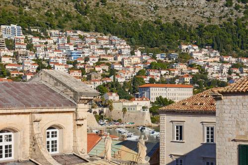 a view of a city with buildings and a mountain at Dominium Premium Location Suites in Dubrovnik