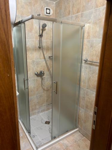 a shower with a glass door in a bathroom at Комплекс Замъка 2 ап 301 in Pamporovo