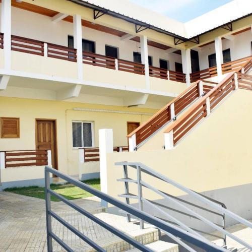 a building with a staircase in front of it at Residencial Aeroporto in São Tomé