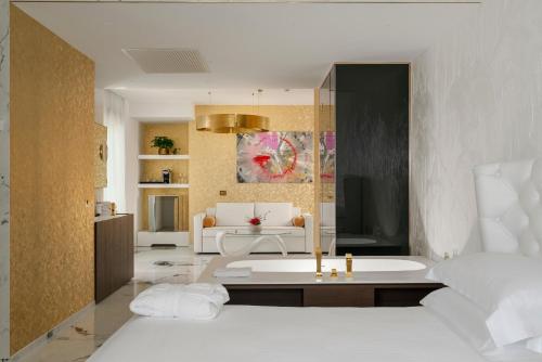 a living room with a couch and a bath tub at The Promenade Luxury Wellness Hotel in Riccione