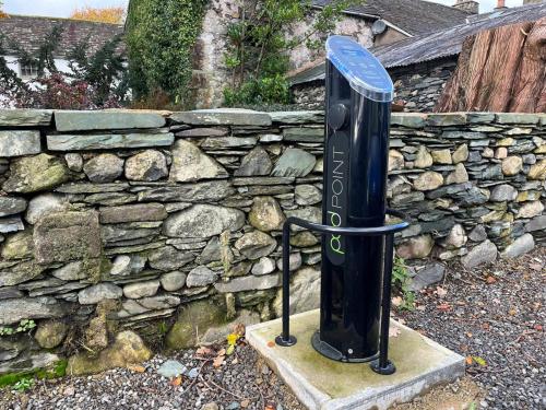 a gas tank in front of a stone wall at Royal Oak Hotel in Rosthwaite