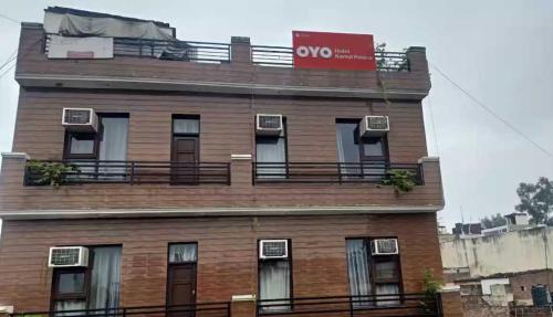 a tall brick building with a noo sign on it at Hotel Kamal Palace in Chandīgarh