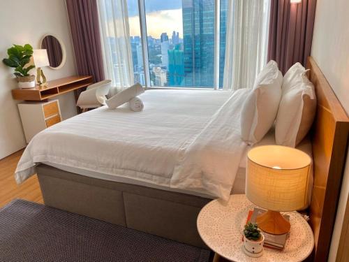 a bedroom with a large bed with a large window at Vortex KLCC Apartment Kuala Lumpur in Kuala Lumpur