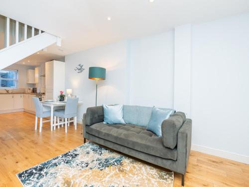 a living room with a couch and a table at Delightful retreat in Larkhall with free parking - Pass the Keys in Bath