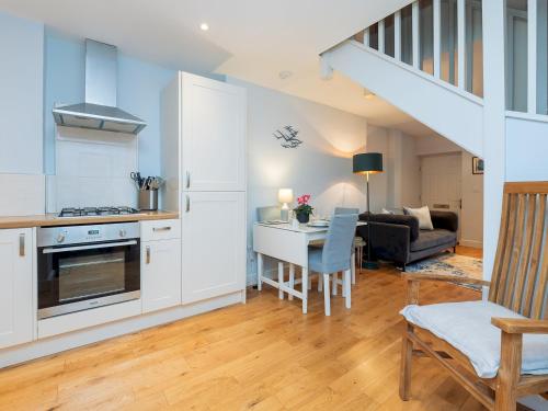 a kitchen and living room with a table and a staircase at Delightful retreat in Larkhall with free parking - Pass the Keys in Bath