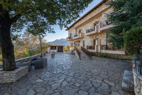 a stone patio in front of a building at Archontiko Fiamegou Hotel&Spa in Synikia Mesi Trikalon