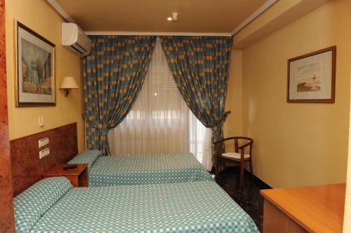 Cama o camas de una habitación en Hostal Venecia