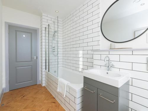 a white bathroom with a sink and a mirror at Pass the Keys Stunning 2 bed retreat in the heart of Bath in Bath