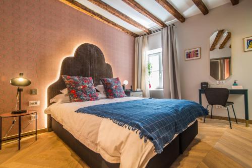 a bedroom with a large bed in a room at The Melegran in Rovinj