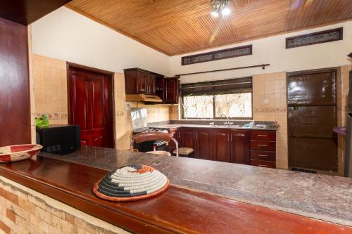 a kitchen with a counter top and a kitchen with a sink at Nilescape Residence in Jinja