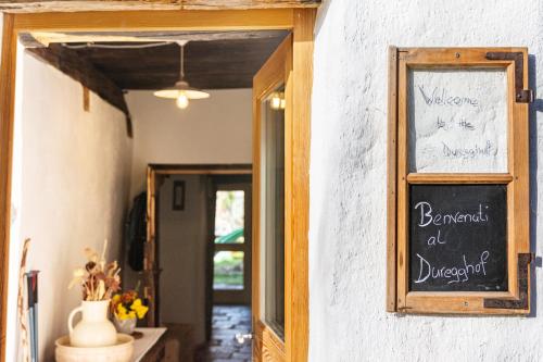 a chalkboard sign on the wall of a restaurant at Historisches Apartment Duregghof in San Genesio Atesino