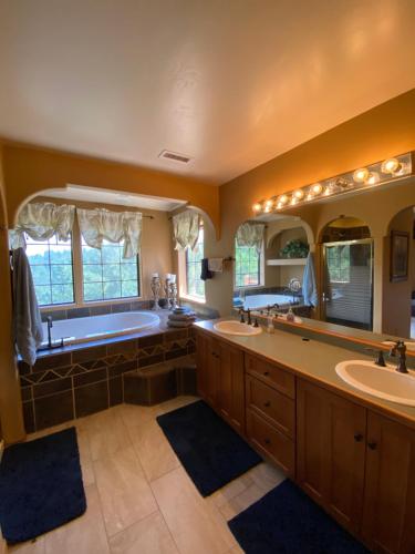 a large bathroom with two sinks and a tub at Ski+Golf+Fishing Flagstaff Kachina Cabin! in Mountainaire