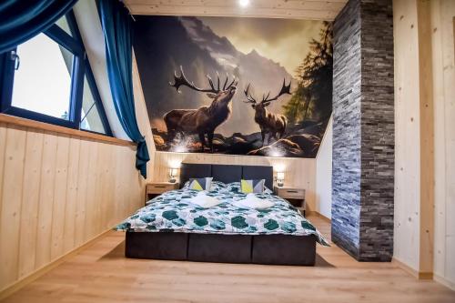 a bedroom with a mural of deer in a forest at Magiczny Domek in Białka Tatrzanska