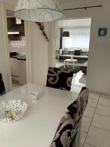 a person sitting at a table in a kitchen at Herz der Weinberge in Gemmrigheim