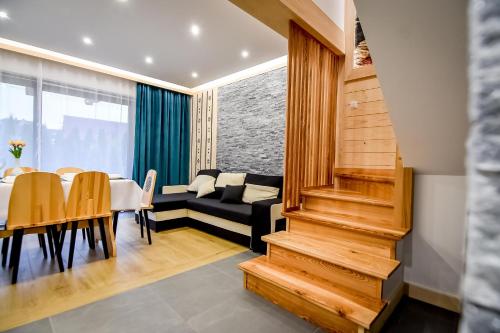 a living room and dining room with a couch and a table at Magiczny Domek in Białka Tatrzanska