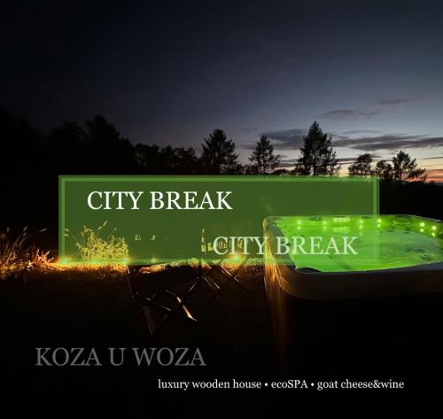 a green sign that reads city break liquidity break at KOZA U WOZA luxury wooden house ecoSPA goat cheese&wine in Szlembark