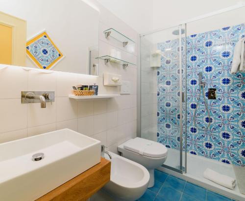 a bathroom with a sink and a toilet and a shower at Hotel La Bussola in Amalfi