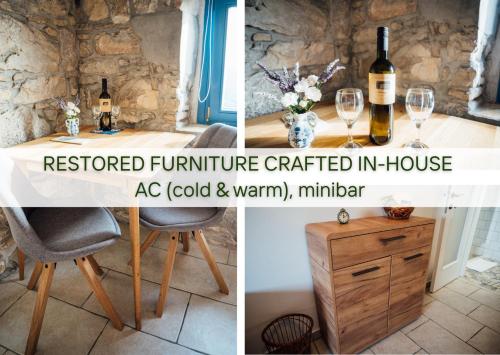 a table with a bottle of wine and a table with wine glasses at Guesthouse Kamniti Rob in Črni Kal