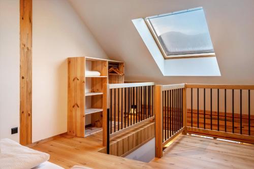 a room with a crib and a skylight at Rotwandterhof Wohnung Bienenstock in Barbiano