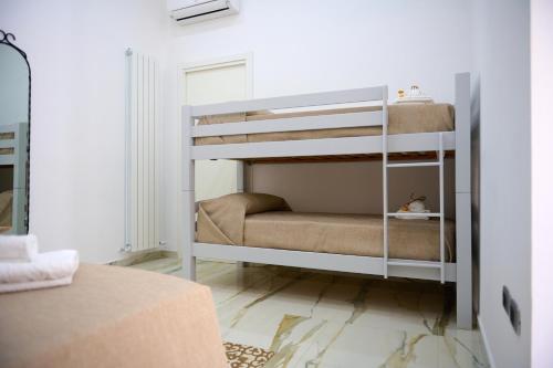 ein weißes Etagenbett in einem weißen Zimmer in der Unterkunft GG HOME in Saviano