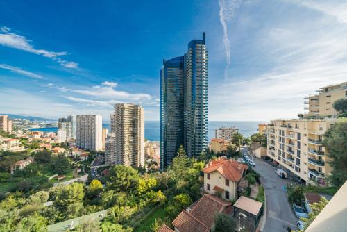 a view of a city with tall buildings at Large terrace, sea view, 5mn from Monaco in Beausoleil