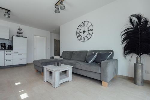 a living room with a couch and a table at Exklusive Ferienwohnungen an der Havel in Werder
