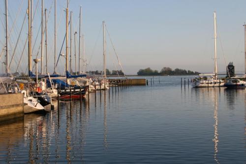 un grupo de barcos atracados en un muelle en el agua en HafenResidenz Fehmarn, en Lemkenhafen auf Fehmarn