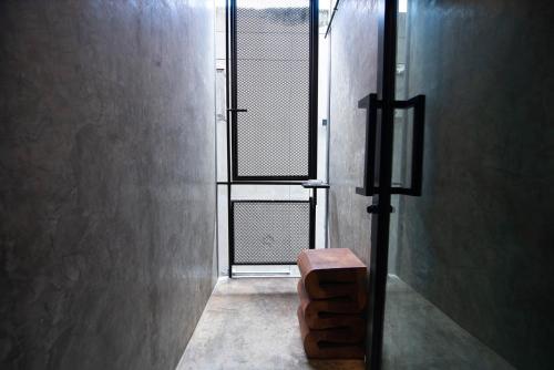 a window in a room with a bench in front of it at The Loft Bar365 in Buriram