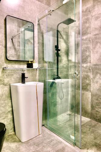 a bathroom with a toilet and a glass shower at HELLO VILLA & SPA in Hue
