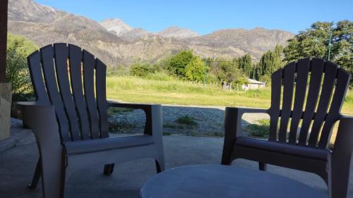 two chairs sitting on a porch with a view of mountains at Rincón Bonito in El Hoyo