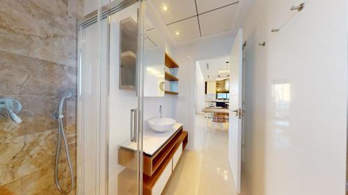 a bathroom with a glass shower and a sink at Elegant apartment with pool AC and balcony in Arenales del Sol