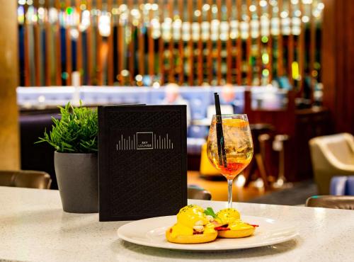 a plate of food and a glass of wine on a table at DoubleTree by Hilton Leeds in Leeds
