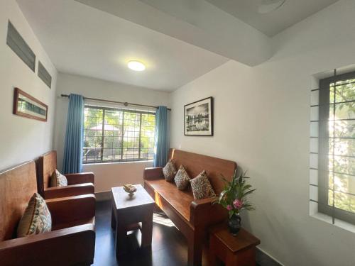 a living room with a couch and a table at The Bliss Angkor in Siem Reap