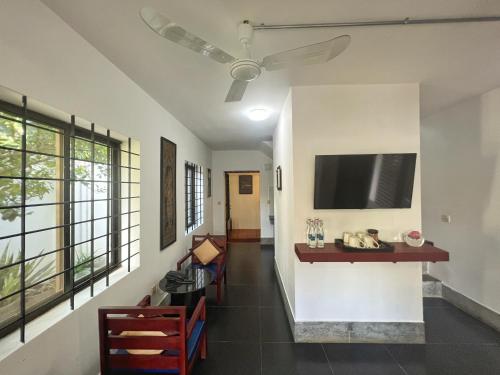 a hallway with a living room with a flat screen tv at The Bliss Angkor in Siem Reap