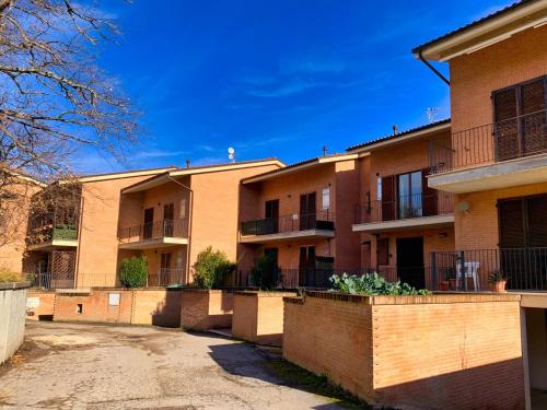 an empty parking lot in front of an apartment building at La casa di Lory in Sarnano