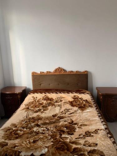 a bed in a room with two nightstands and a bed with a blanket at Agarak House 