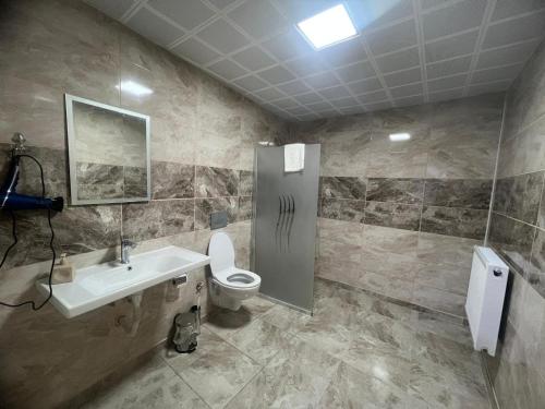 a bathroom with a sink and a toilet at Köprücü Hotel in Diyarbakır