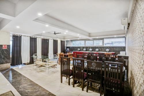 a dining room with black chairs and a table at Townhouse 22956 Hotel Grand Residency in Greater Noida